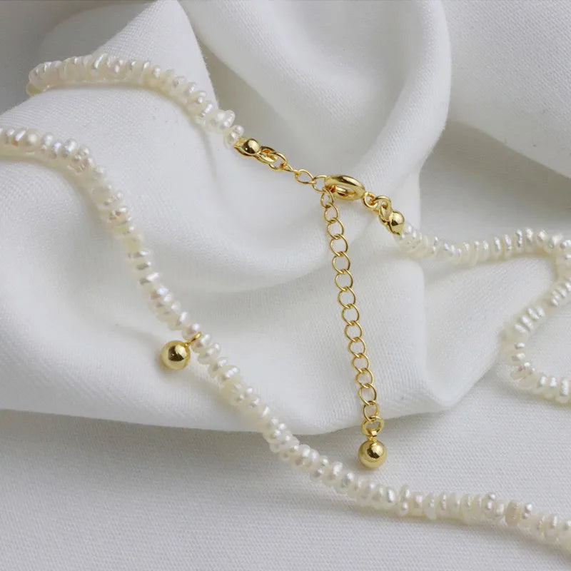 luxurytreasury Very fine freshwater shaped Baroque rice pearl necklace, metal texture clavicle chain, small golden bean pendant